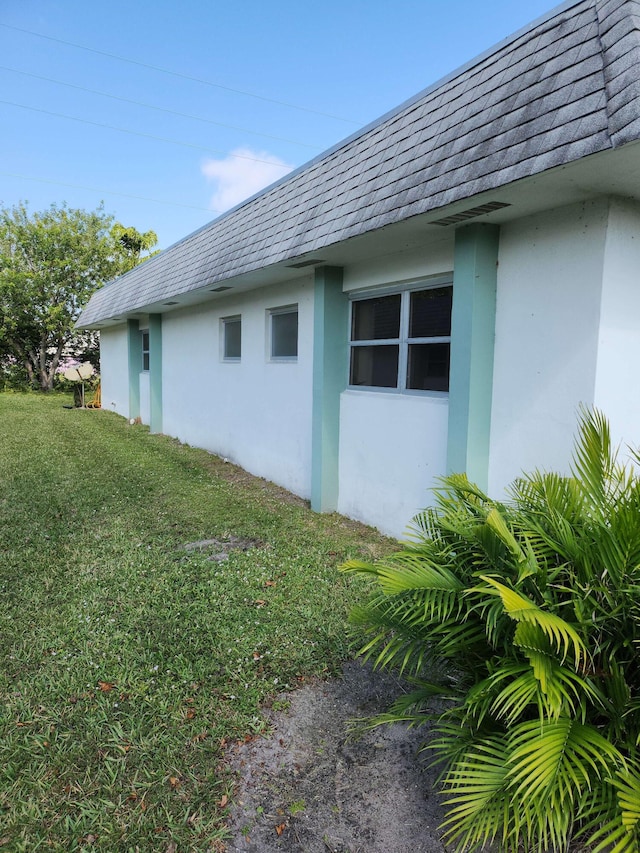 view of home's exterior with a lawn