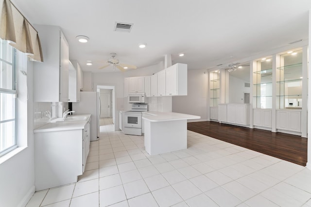kitchen with ceiling fan, white appliances, light countertops, white cabinetry, and recessed lighting