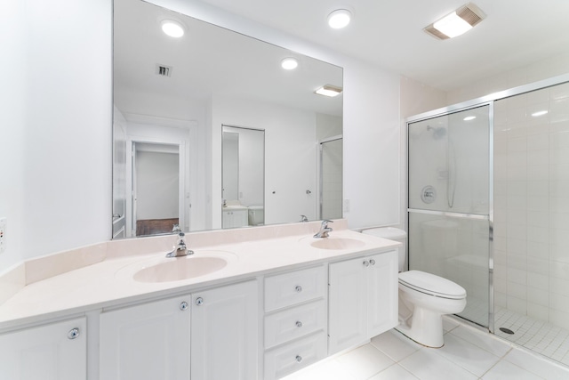 bathroom featuring a stall shower, double vanity, tile patterned flooring, recessed lighting, and toilet