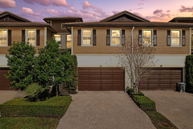 view of front of property featuring a garage, driveway, and stucco siding