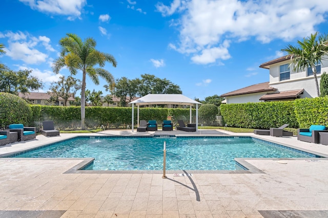 view of pool featuring a patio, pool water feature, and a gazebo