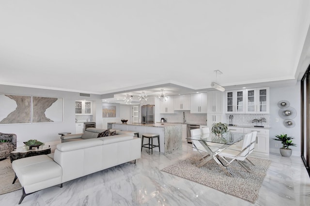 living room featuring sink and crown molding