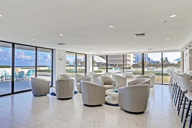 living room with a wall of windows and a wealth of natural light