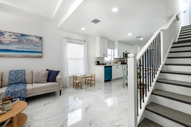 living area with recessed lighting, stairway, marble finish floor, and visible vents