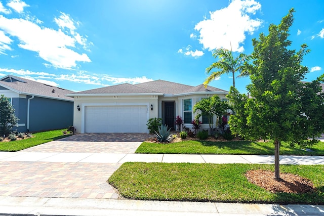 view of front of home with a front lawn and a garage