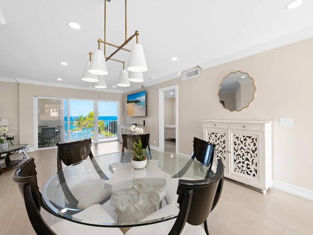 dining space featuring light hardwood / wood-style floors and crown molding