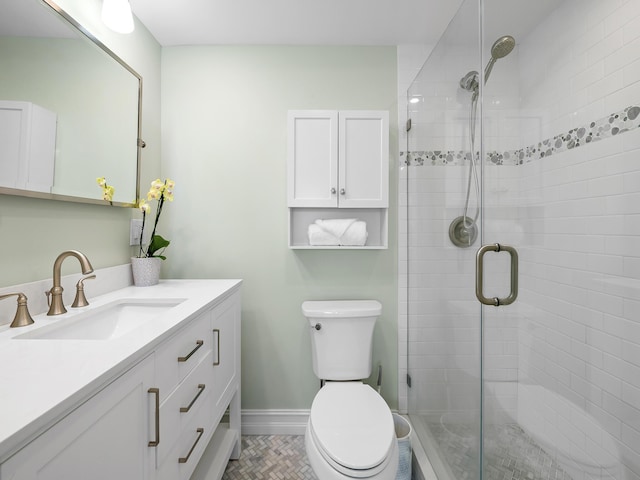 bathroom with vanity, an enclosed shower, and toilet