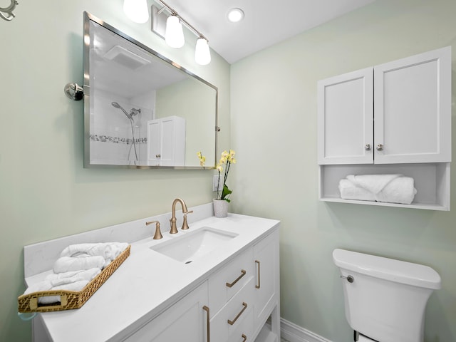 bathroom featuring vanity, toilet, and walk in shower