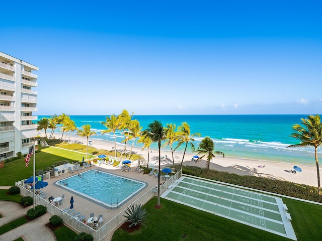 exterior space with a water view and a beach view