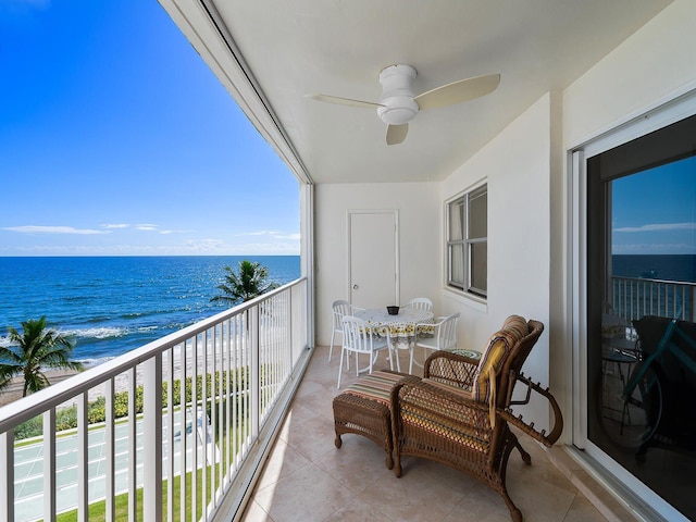 balcony featuring a water view and ceiling fan