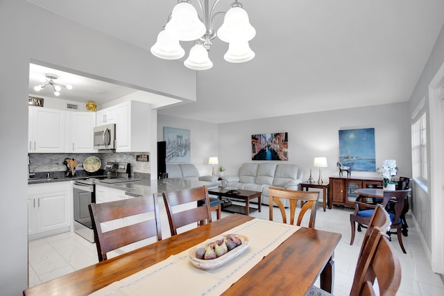 dining space featuring an inviting chandelier and visible vents