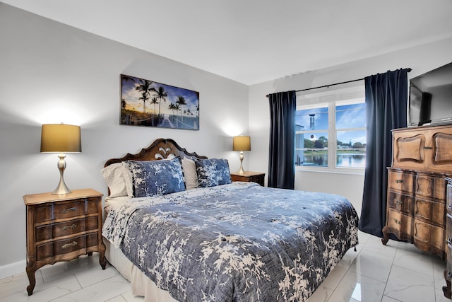 bedroom featuring marble finish floor