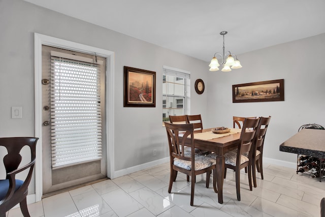 dining space featuring marble finish floor, a wealth of natural light, and baseboards