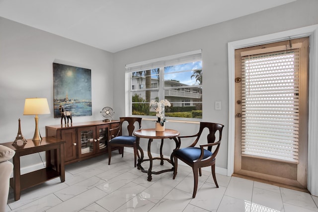 living area with marble finish floor and baseboards