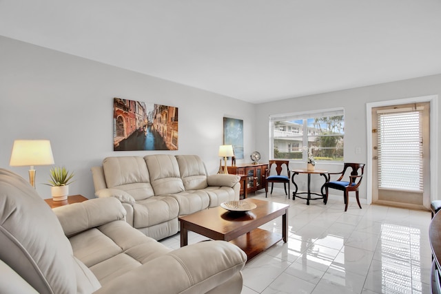 living area featuring marble finish floor and baseboards