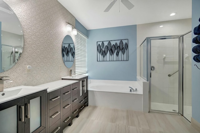 full bathroom with a ceiling fan, a stall shower, a garden tub, and vanity