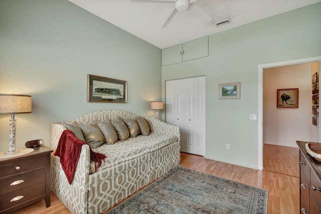 bedroom with a closet, visible vents, ceiling fan, and light wood-style flooring