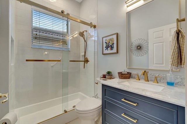 full bathroom with toilet, a shower stall, and vanity