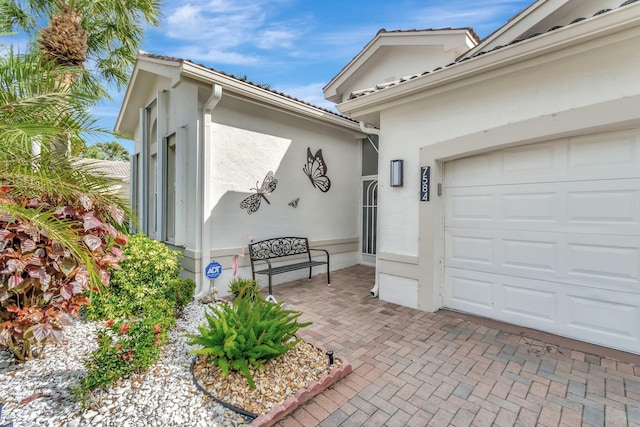 exterior space featuring a garage and stucco siding