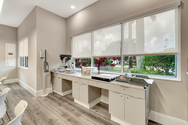 home office with recessed lighting, light wood-type flooring, and baseboards