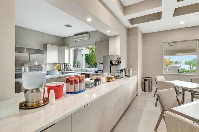 kitchen with recessed lighting, a sink, white cabinets, a wall mounted air conditioner, and modern cabinets