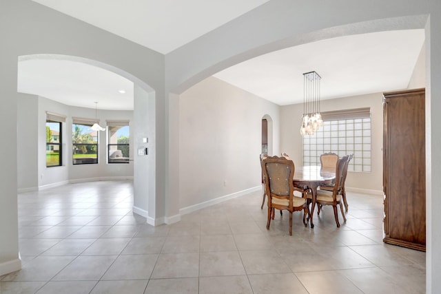 dining space with light tile patterned flooring and a chandelier