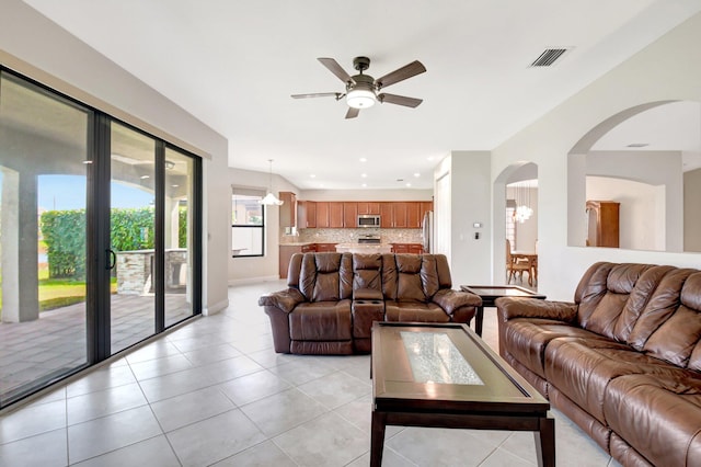 living room featuring light tile patterned flooring and ceiling fan