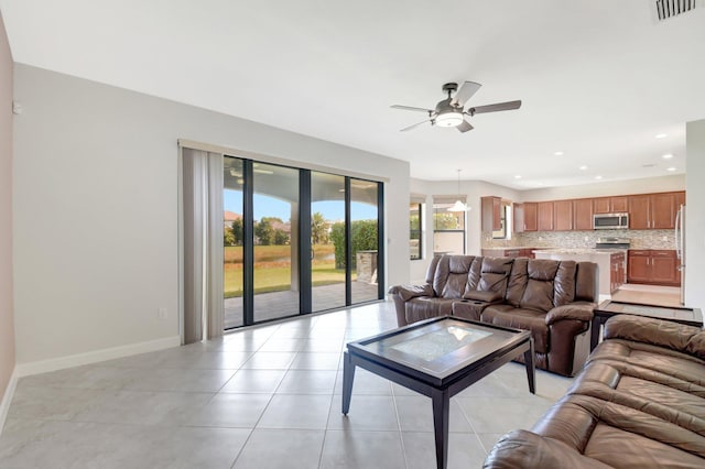 living room with ceiling fan and light tile patterned flooring