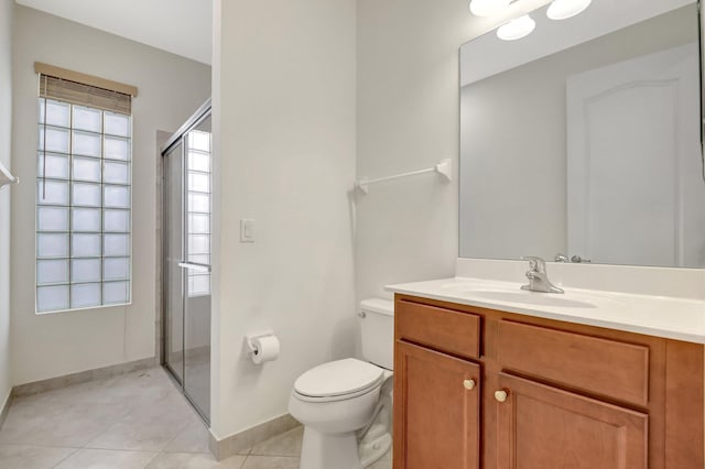 bathroom with tile patterned floors, vanity, toilet, and walk in shower