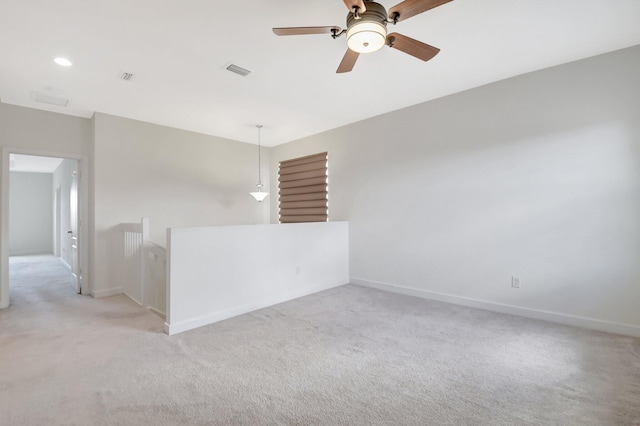 empty room featuring light carpet and ceiling fan