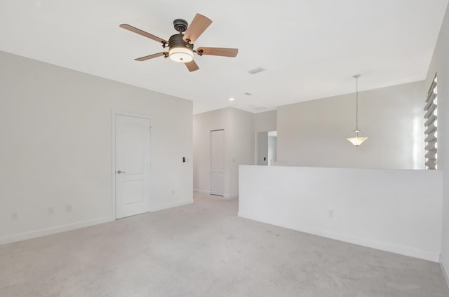 carpeted empty room featuring ceiling fan