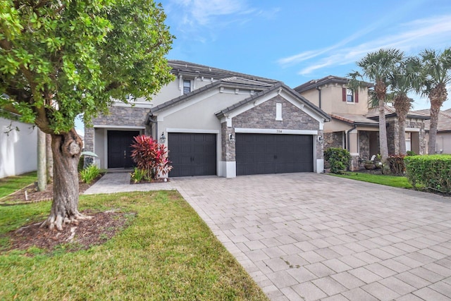 view of front of house featuring a front yard and a garage