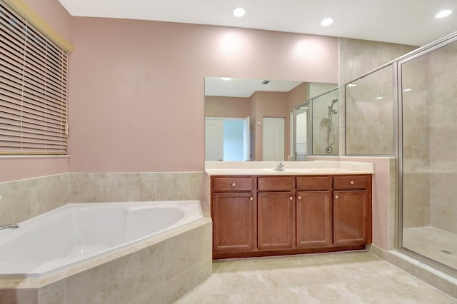 bathroom with separate shower and tub and vanity