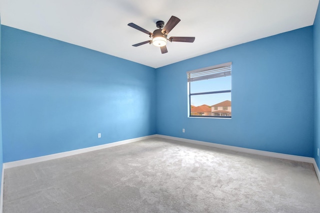 carpeted spare room with ceiling fan