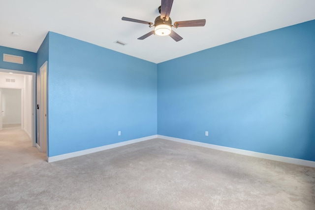 unfurnished room with light colored carpet and ceiling fan