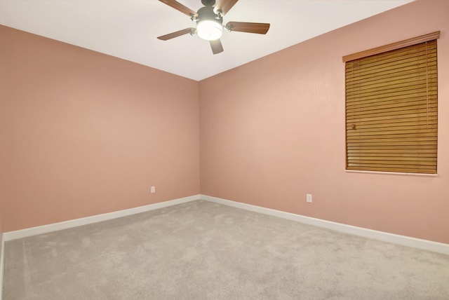 empty room featuring ceiling fan and carpet