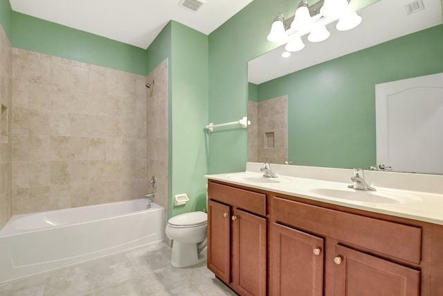 full bathroom featuring tile patterned flooring, vanity, toilet, and tiled shower / bath