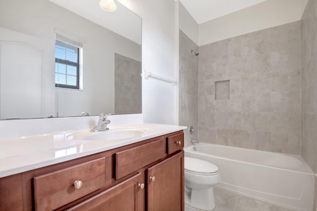 full bathroom with tile patterned floors, toilet, vanity, and tiled shower / bath combo