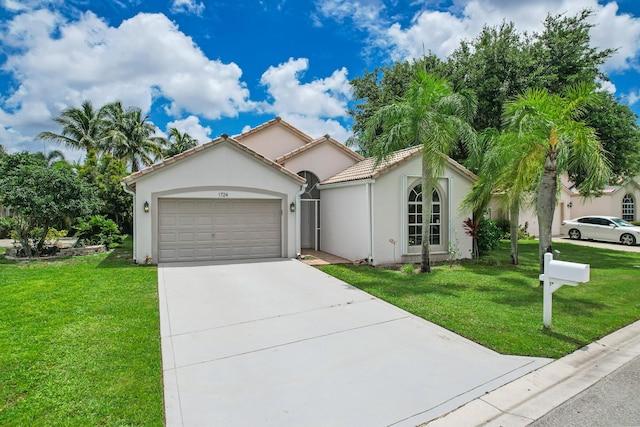 view of front of house featuring a garage, concrete driveway, a tile roof, a front yard, and stucco siding