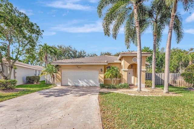 view of front facade featuring a tile roof, stucco siding, an attached garage, fence, and driveway