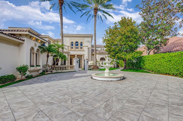 exterior space featuring a tiled roof and stucco siding