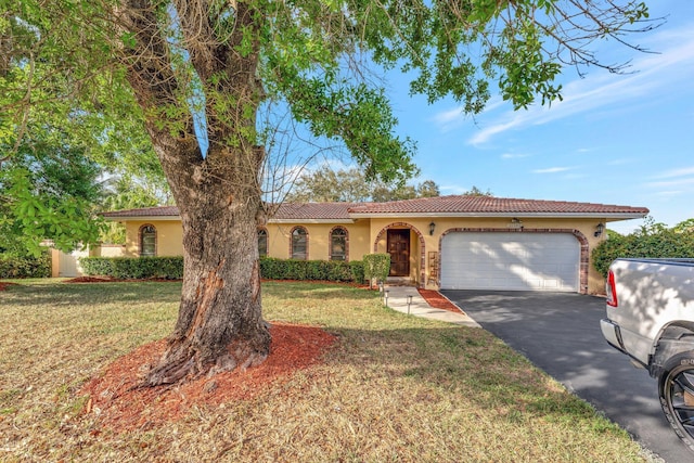 view of front of property with a garage and a front lawn