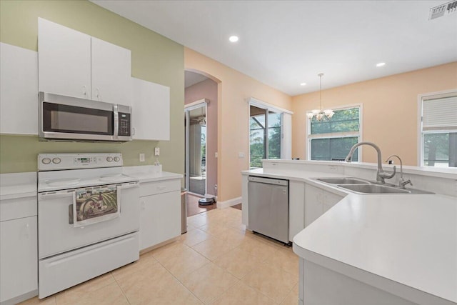 kitchen featuring white cabinetry, stainless steel appliances, sink, light tile patterned floors, and pendant lighting