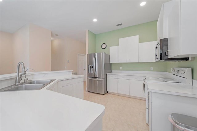 kitchen with appliances with stainless steel finishes, sink, and white cabinets