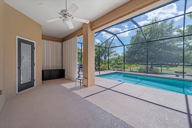 view of pool featuring a patio area, ceiling fan, and glass enclosure