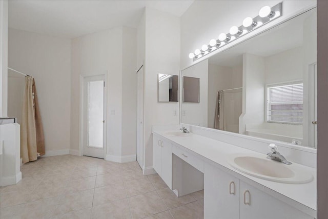 bathroom featuring tile patterned flooring, independent shower and bath, and vanity