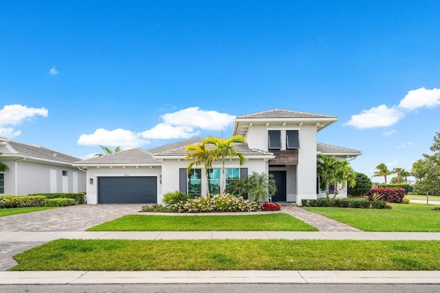 view of front of home with a front lawn and a garage