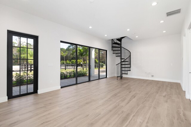 unfurnished living room with light hardwood / wood-style floors