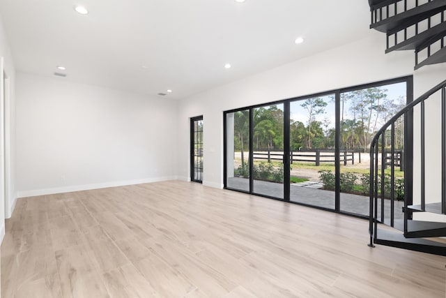 unfurnished room with light hardwood / wood-style flooring