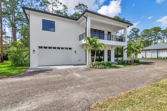 view of front of home with a garage and a balcony